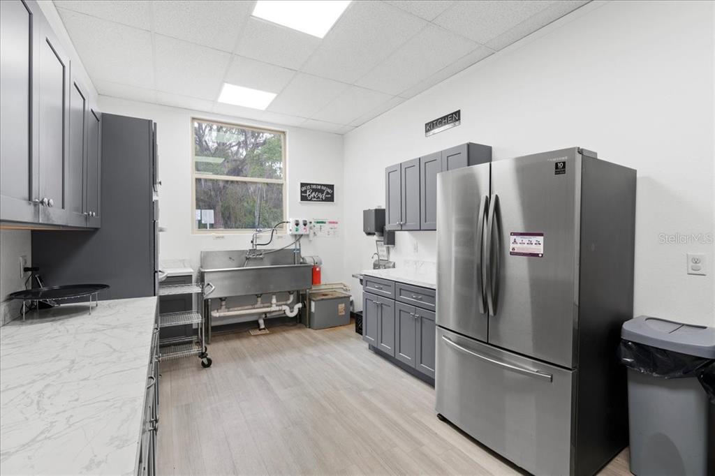 1938 Northeast Waldo Road Gainesville, FL 32609 - Photo 14 of 64 a kitchen with stainless steel appliances a refrigerator and a stove top oven
