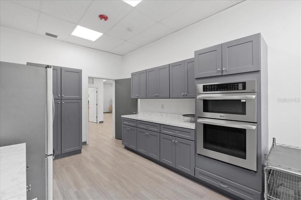 1938 Northeast Waldo Road Gainesville, FL 32609 - Photo 15 of 64 a kitchen with cabinets and stainless steel appliances