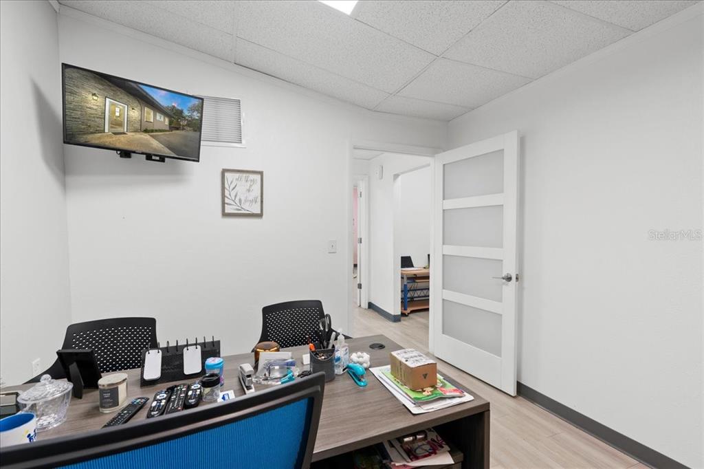 1938 Northeast Waldo Road Gainesville, FL 32609 - Photo 19 of 64 a view of a workspace with furniture and wooden floor