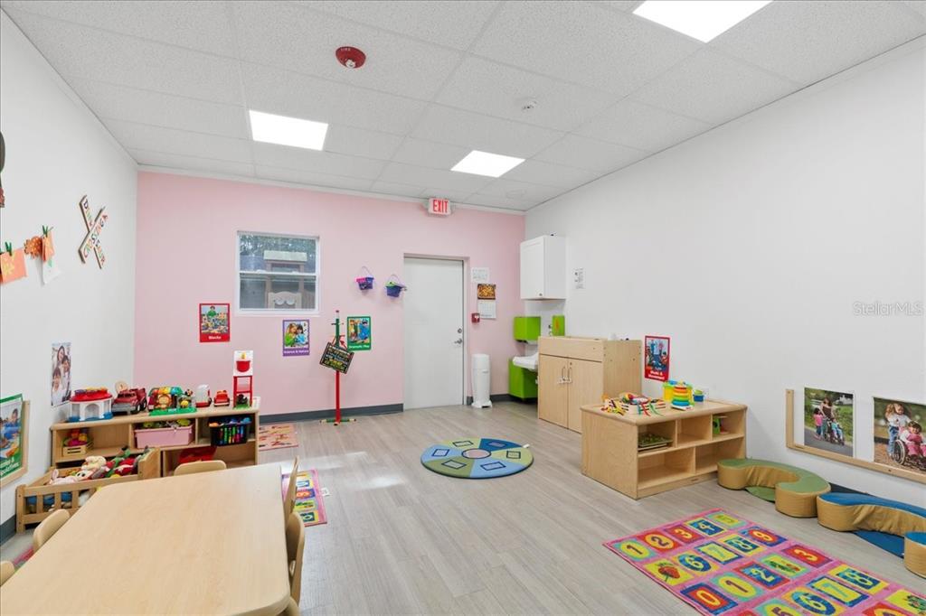1938 Northeast Waldo Road Gainesville, FL 32609 - Photo 21 of 64 a room with furniture a rug toys and wooden floor