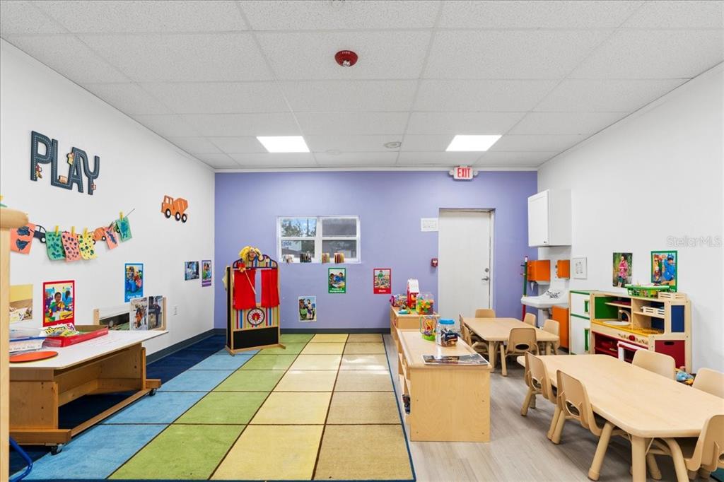 1938 Northeast Waldo Road Gainesville, FL 32609 - Photo 23 of 64 a living room with furniture gym equipment and a table