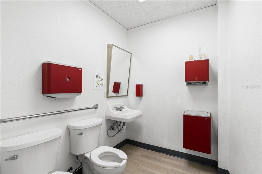 1938 Northeast Waldo Road Gainesville, FL 32609 - Photo 28 of 64 a white toilet sitting next to a bathroom sink