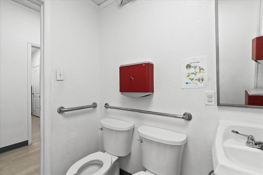 1938 Northeast Waldo Road Gainesville, FL 32609 - Photo 29 of 64 a white toilet sitting next to a bathroom sink