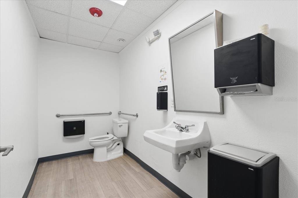 1938 Northeast Waldo Road Gainesville, FL 32609 - Photo 37 of 64 a bathroom with a sink toilet and mirror