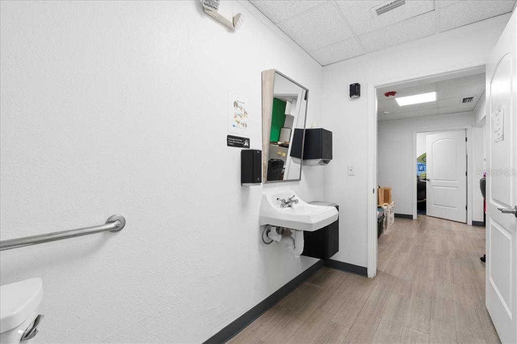 1938 Northeast Waldo Road Gainesville, FL 32609 - Photo 38 of 64 a view of a room with a sink and mirror