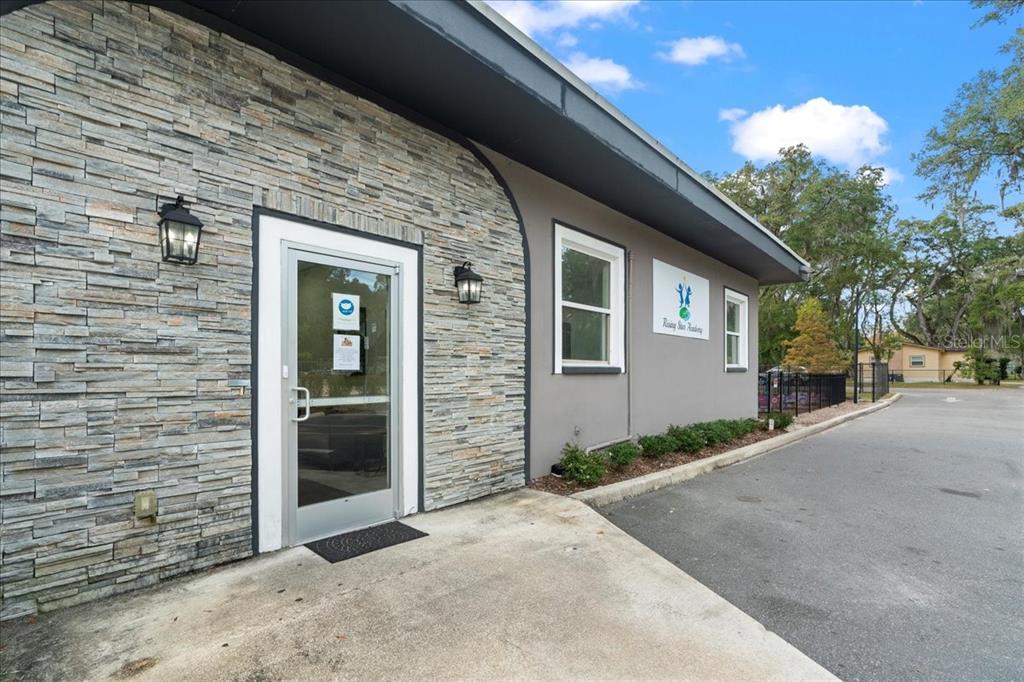 1938 Northeast Waldo Road Gainesville, FL 32609 - Photo 41 of 64 a front view of a house with a yard