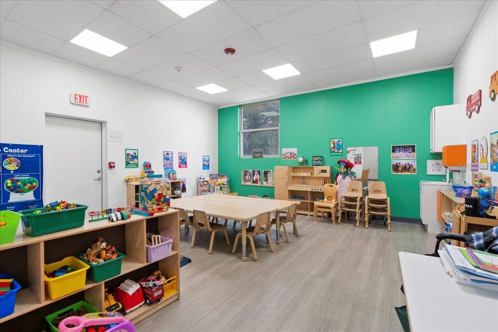1938 Northeast Waldo Road Gainesville, FL 32609 - Photo 10 of 64 a playing room with furniture and a wooden floor