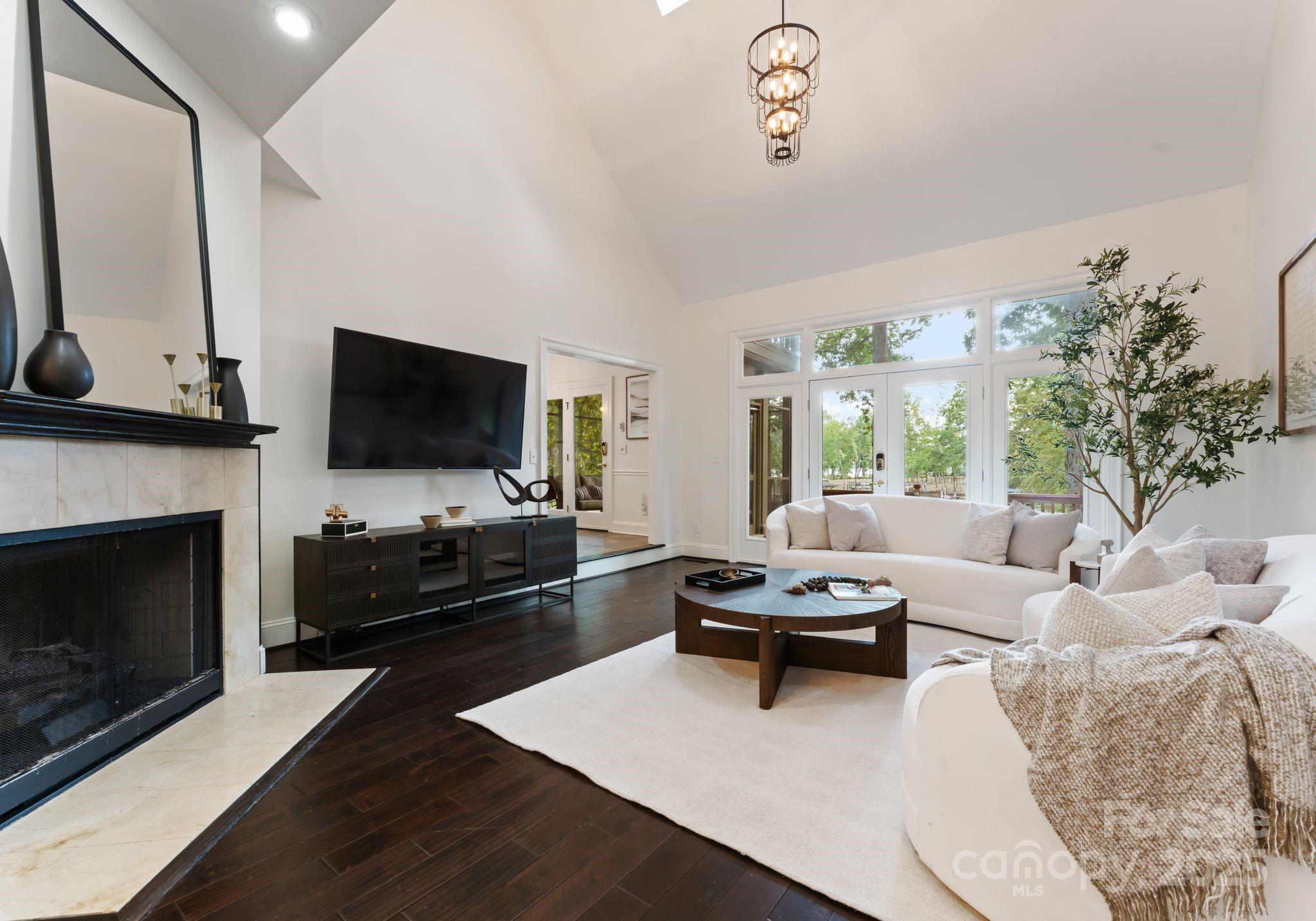252 Greyfriars Road Mooresville, NC 28117 - Photo 13 of 46 a living room with furniture a flat screen tv and a fireplace