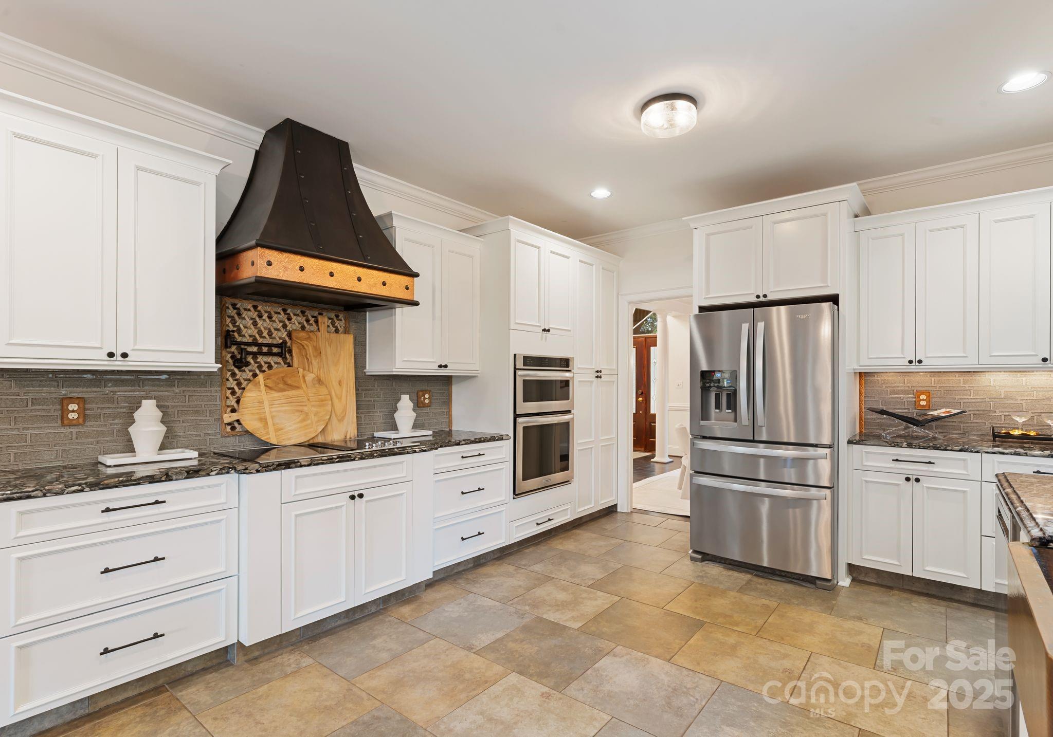 252 Greyfriars Road Mooresville, NC 28117 - Photo 15 of 46 a kitchen with granite countertop white cabinets and stainless steel appliances