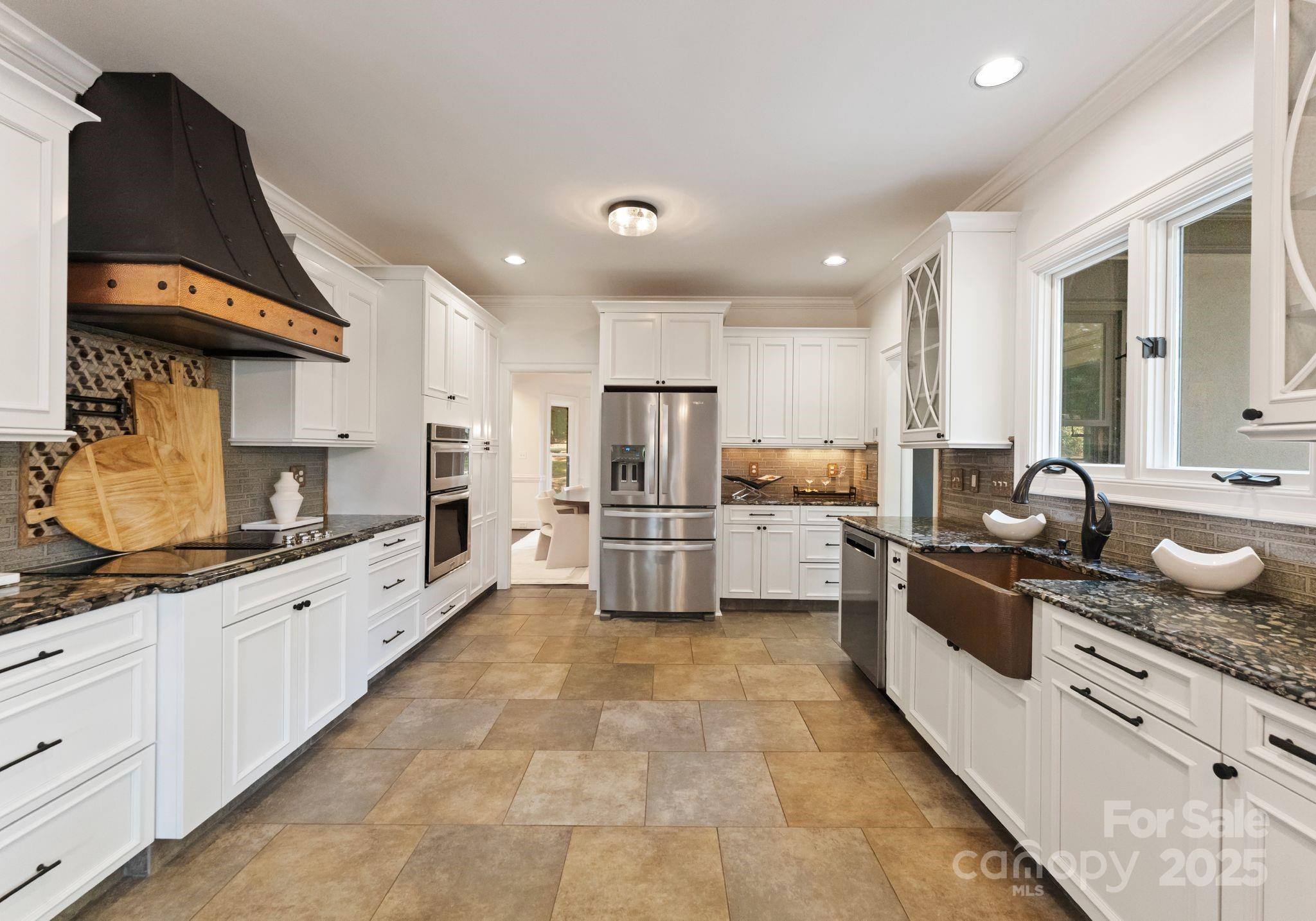 252 Greyfriars Road Mooresville, NC 28117 - Photo 16 of 46 a large kitchen with stainless steel appliances lots of counter space sink and cabinets