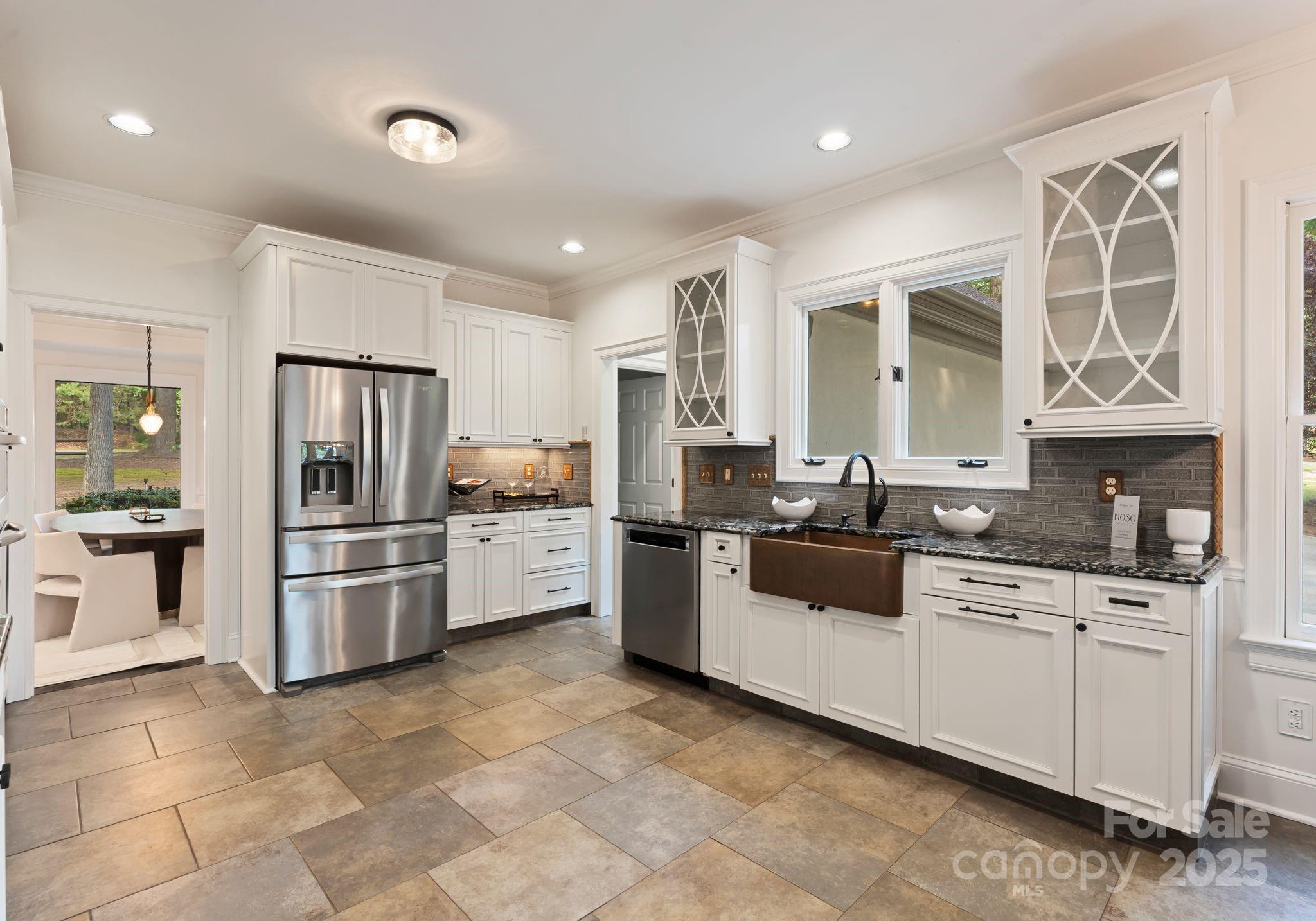 252 Greyfriars Road Mooresville, NC 28117 - Photo 17 of 46 a kitchen with stainless steel appliances a refrigerator sink and cabinets