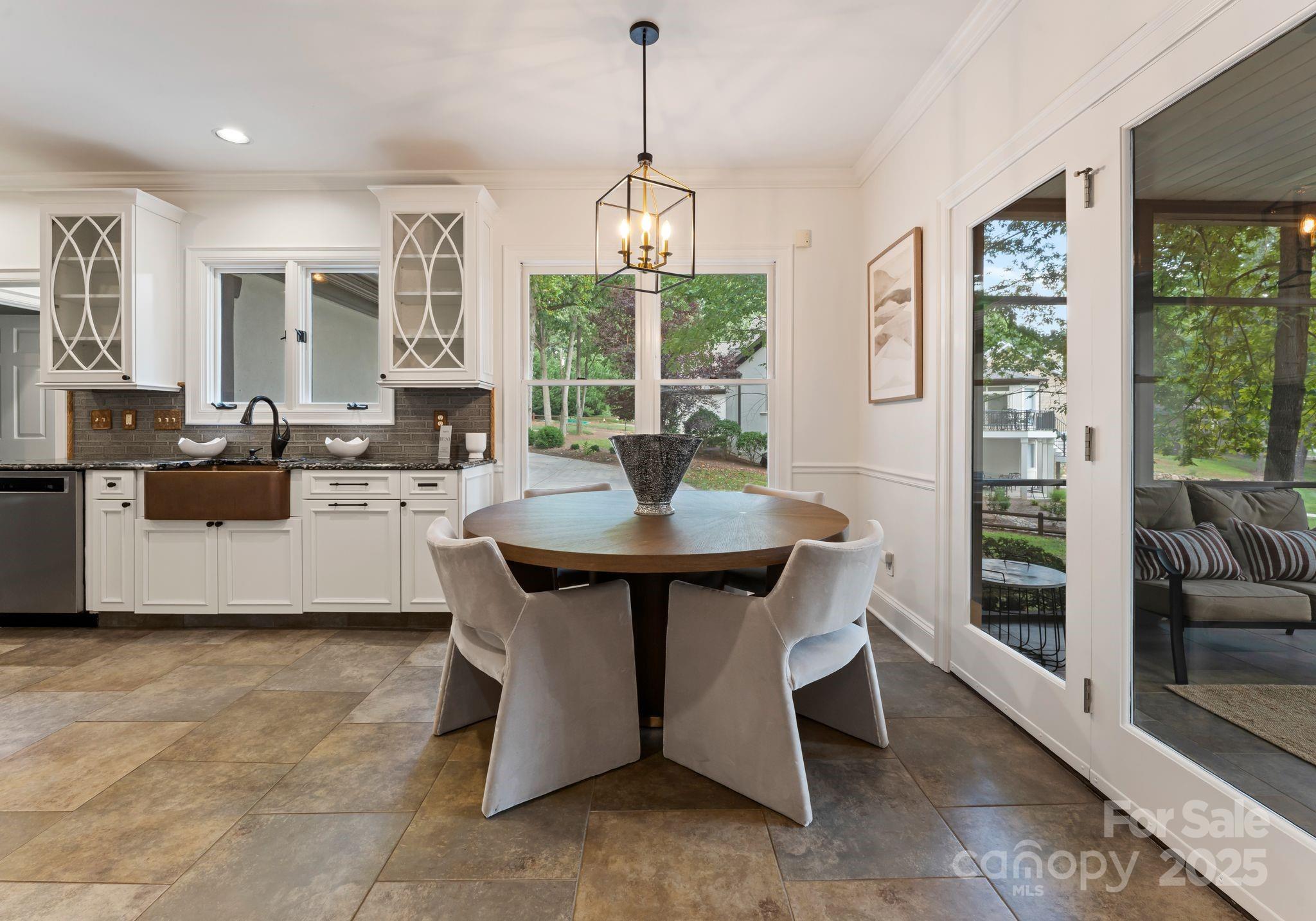 252 Greyfriars Road Mooresville, NC 28117 - Photo 18 of 46 a living room with furniture a window and a chandelier