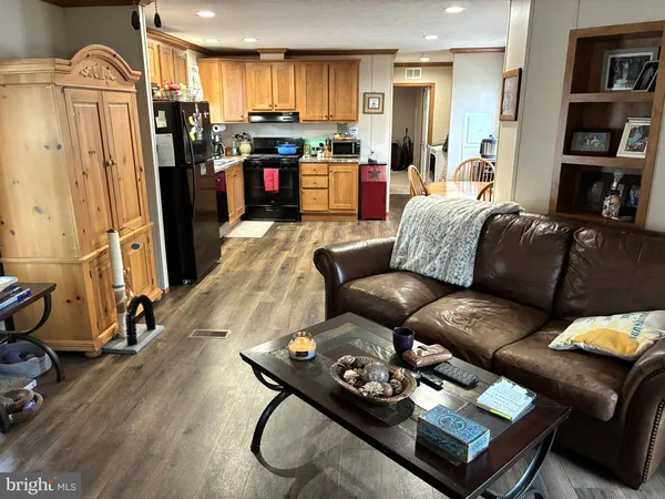 a living room with furniture or couch and a bookshelf