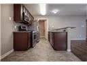 a view of a kitchen with stainless steel appliances granite countertop a refrigerator and a wooden cabinets