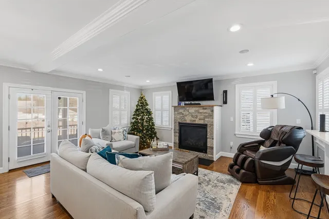 a living room with furniture a fireplace and a flat screen tv