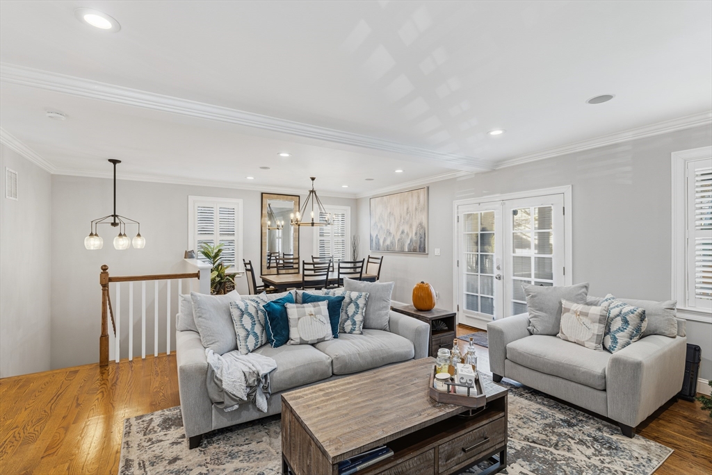 491 Washington Street, Unit 1 Braintree, MA 02184 - Photo 14 of 42 a living room with furniture or couches and a dining table with wooden floor