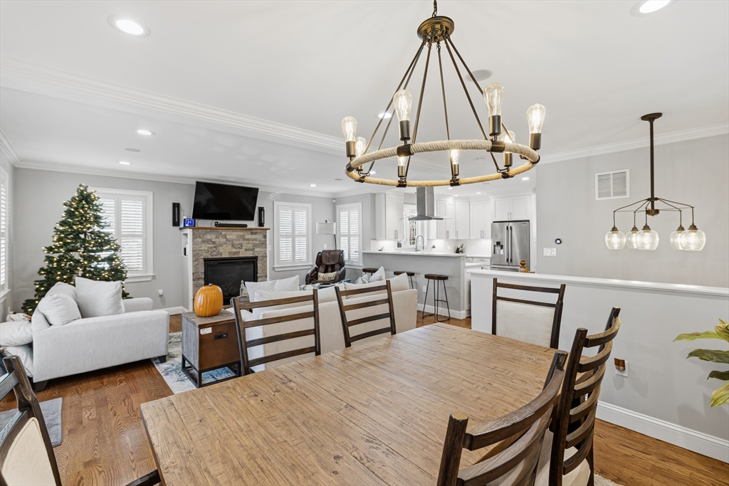 491 Washington Street, Unit 1 Braintree, MA 02184 - Photo 15 of 42 a living room with furniture a fireplace and a flat screen tv