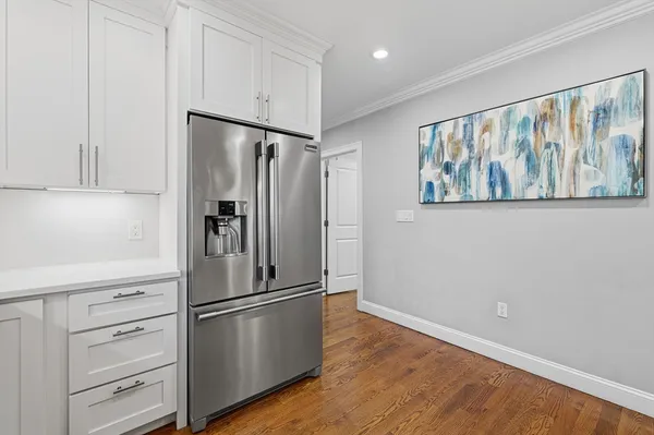 a kitchen with stainless steel appliances a refrigerator and cabinets