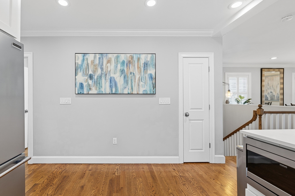491 Washington Street, Unit 1 Braintree, MA 02184 - Photo 18 of 42 a view of an empty room with wooden floor and a window
