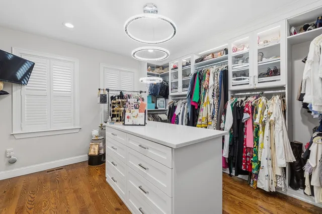 a view of walk in closet with clothes and shoes