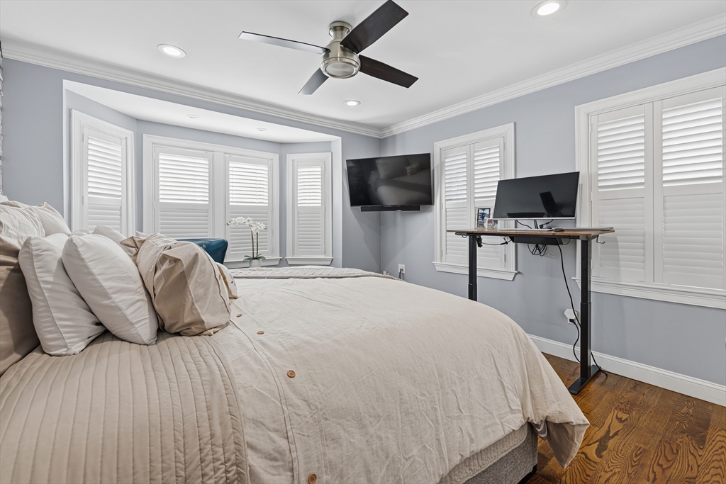 491 Washington Street, Unit 1 Braintree, MA 02184 - Photo 23 of 42 a bedroom with a bed and a flat screen tv