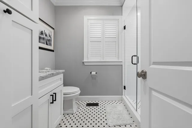 a bathroom with a sink a toilet and a shower