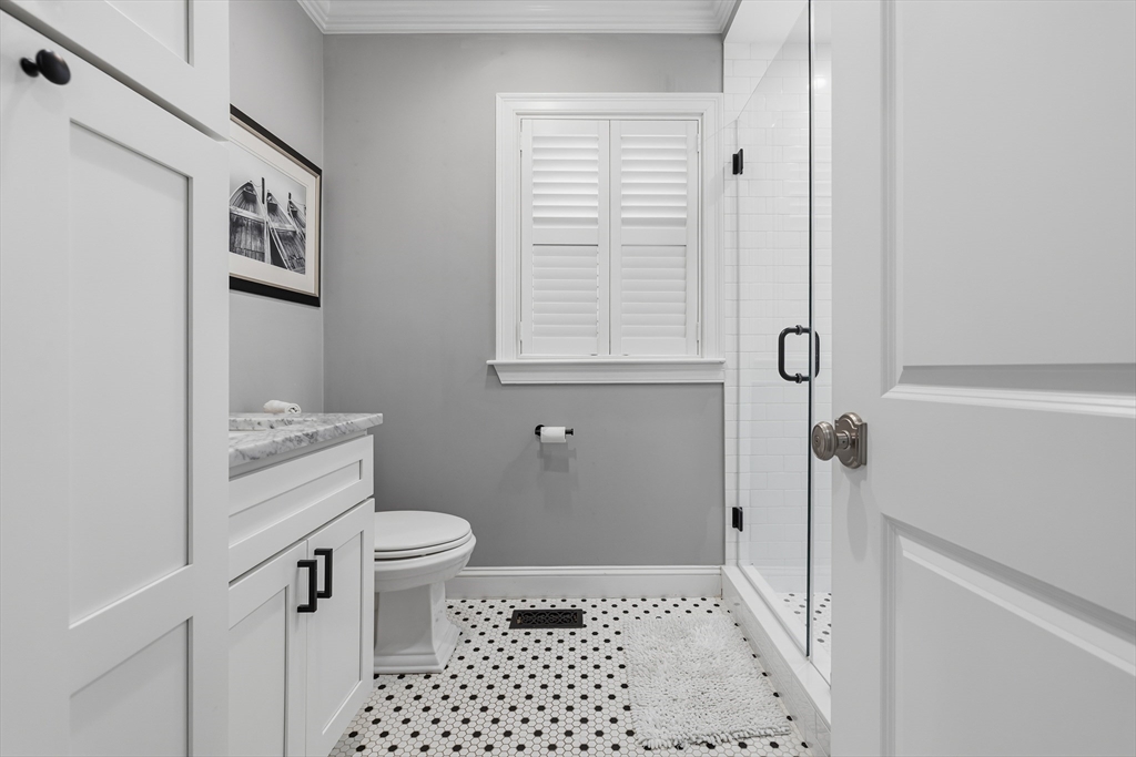 491 Washington Street, Unit 1 Braintree, MA 02184 - Photo 26 of 42 a bathroom with a sink a toilet and a shower