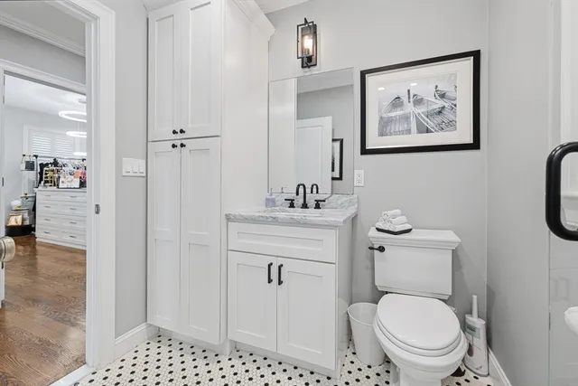 a bathroom with a toilet a sink and glass door