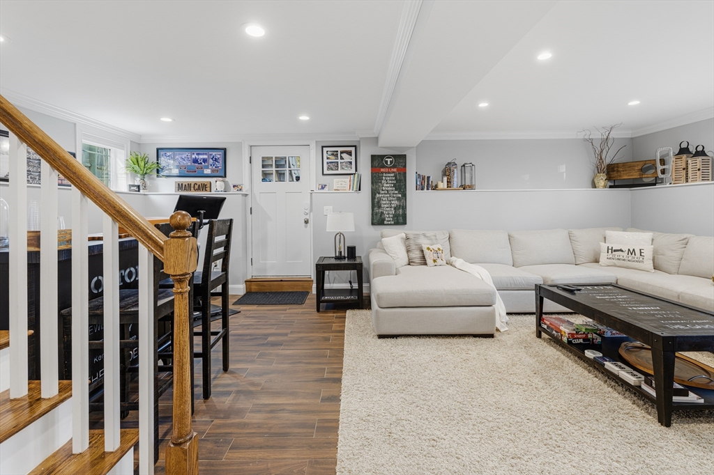 491 Washington Street, Unit 1 Braintree, MA 02184 - Photo 29 of 42 a living room with furniture and a flat screen tv