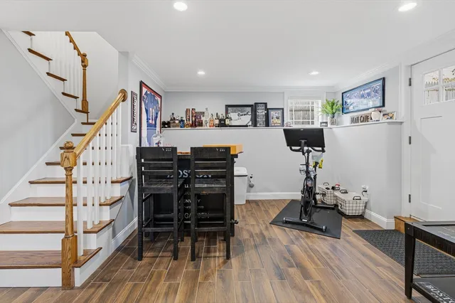 a view of a room with furniture and wooden floor