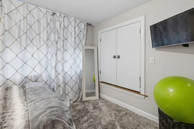 a view of a livingroom with wooden floor and cabinet