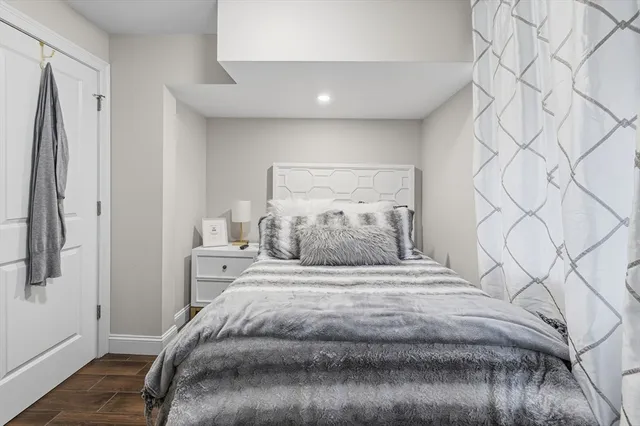 a bedroom with a bed and a white wall