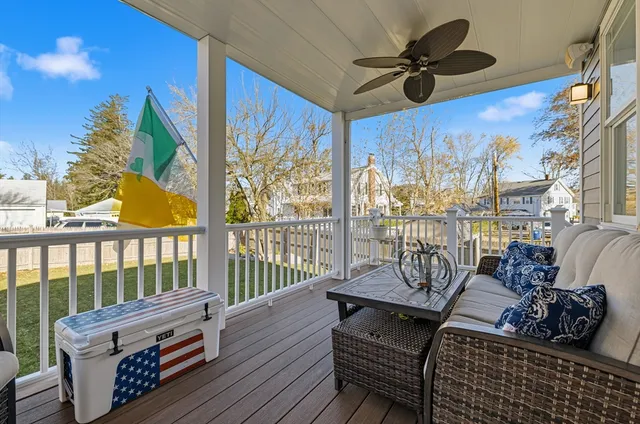 a view of a balcony with furniture and wooden floor