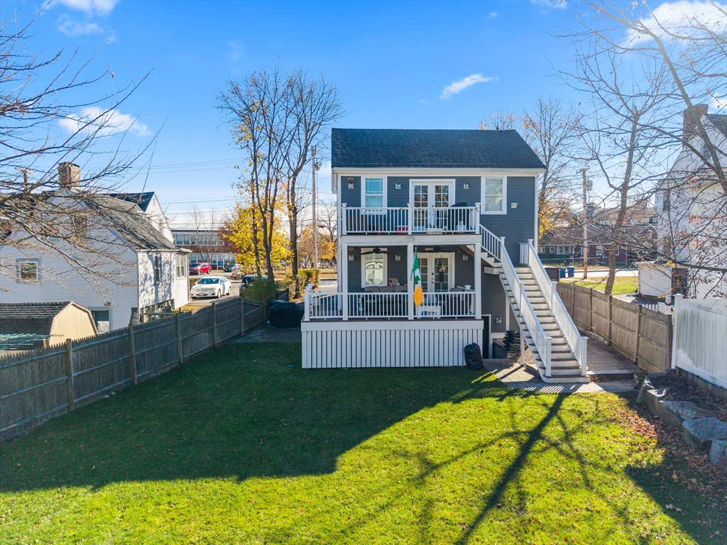 491 Washington Street, Unit 1 Braintree, MA 02184 - Photo 41 of 42 a front view of a house with a garden and yard