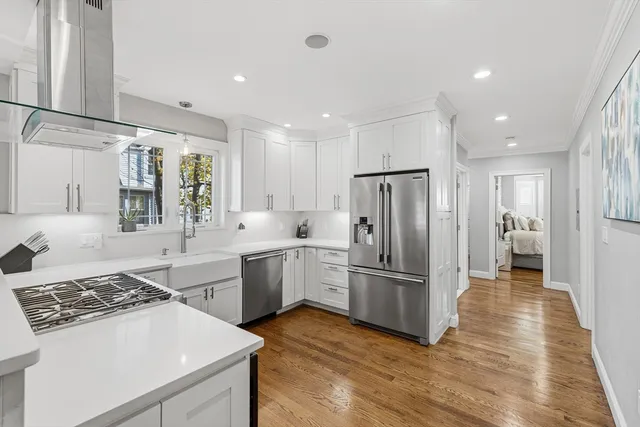 a kitchen with a sink stainless steel appliances and cabinets