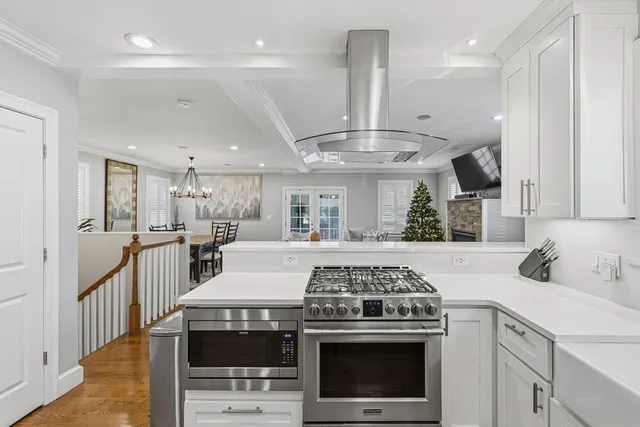 a kitchen with a stove and white cabinets