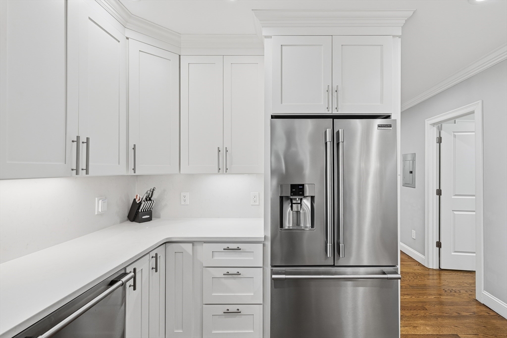 491 Washington Street, Unit 1 Braintree, MA 02184 - Photo 8 of 42 a kitchen with a refrigerator a sink and cabinets