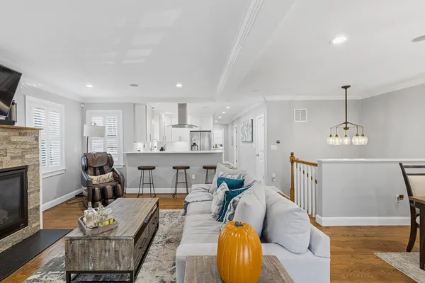 a living room with furniture kitchen view and a fireplace