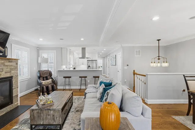 a living room with furniture kitchen view and a fireplace