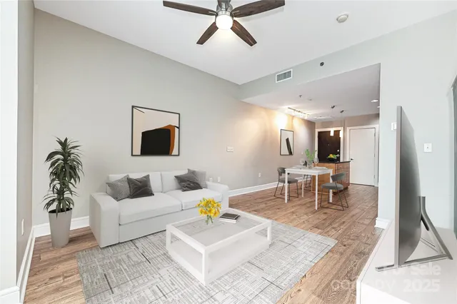 a living room with furniture and wooden floor