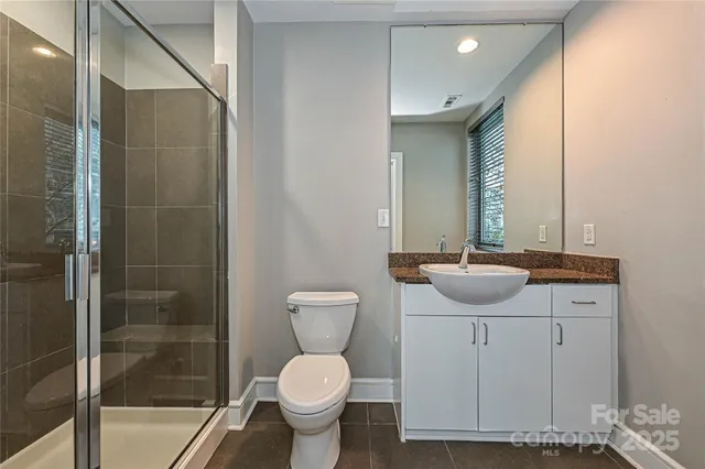a bathroom with a sink toilet a mirror and shower
