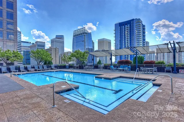 a swimming pool with outdoor seating yard and plants