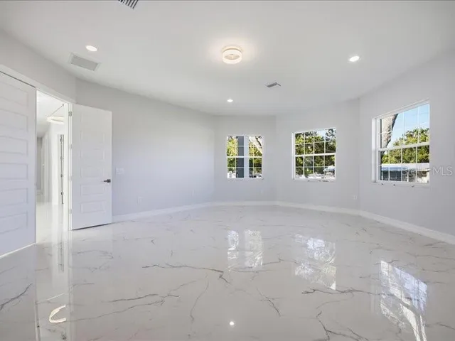 a view of an empty room with windows