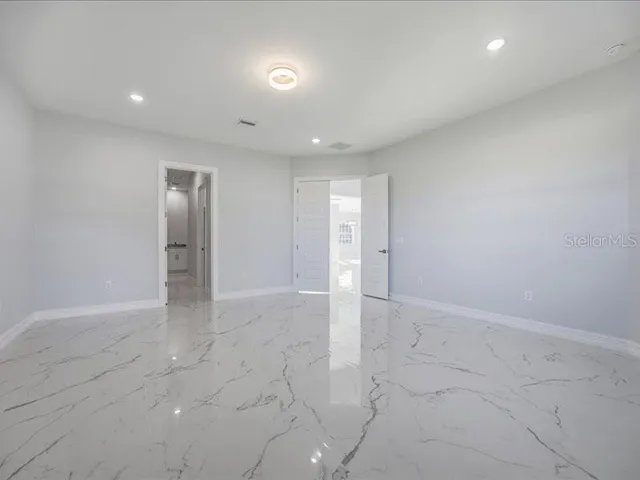 an empty room with white walls and tiles