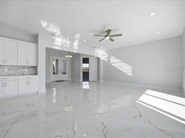 a view of a kitchen with a sink and chandelier