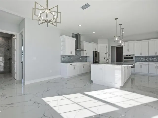 a large kitchen with kitchen island granite countertop a counter space and cabinets