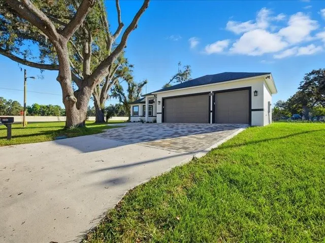 a front view of a house with a yard and garage