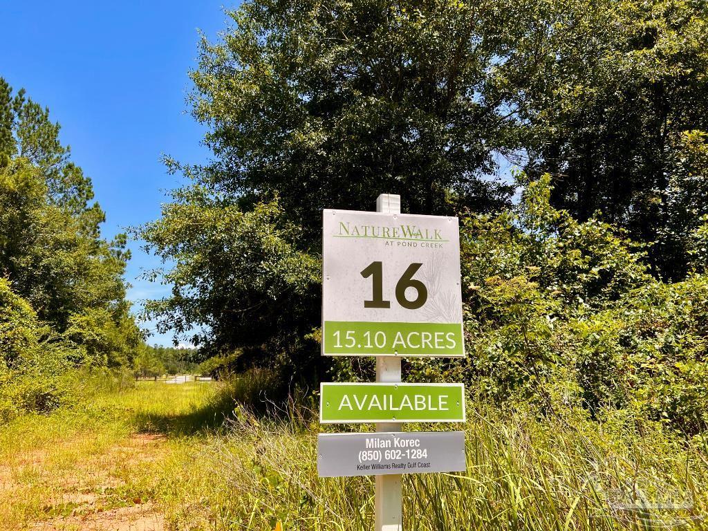 Lot 16 Naturewalk Drive Milton, FL 32571 - Photo 2 of 35 a sign that is sitting on a brick wall