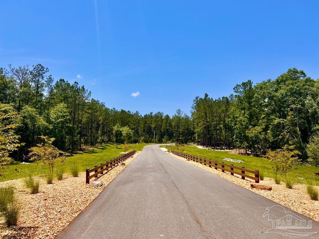 Lot 16 Naturewalk Drive Milton, FL 32571 - Photo 31 of 35 a view of a swimming pool with an outdoor space and seating area