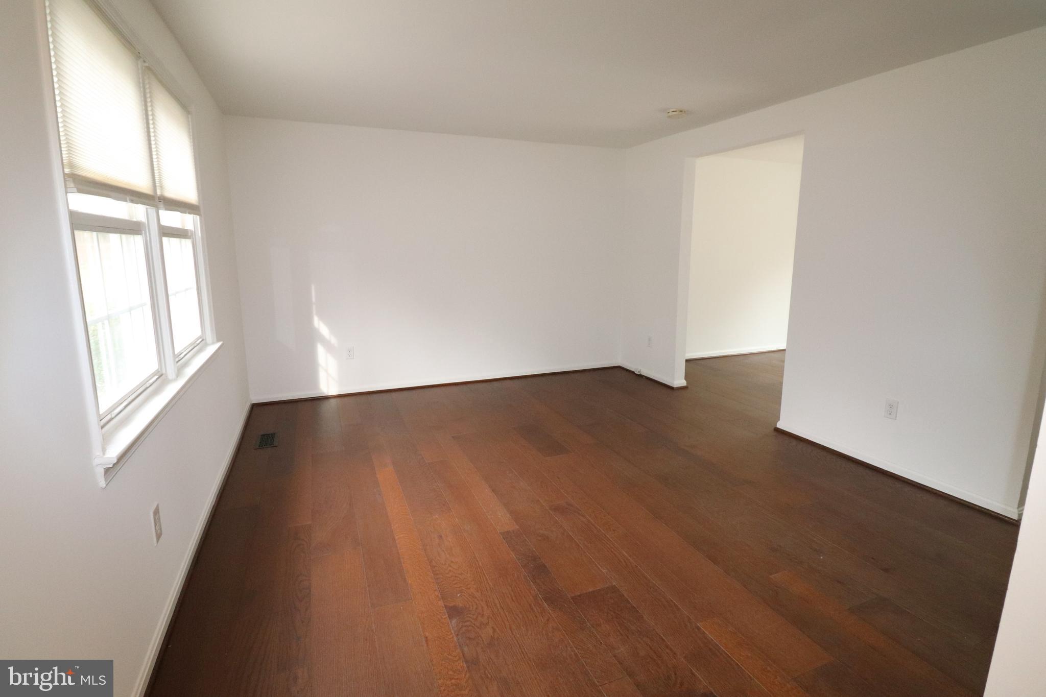 138 Sharpstead Lane Gaithersburg, MD 20878 - Photo 3 of 36 an empty room with wooden floor and windows
